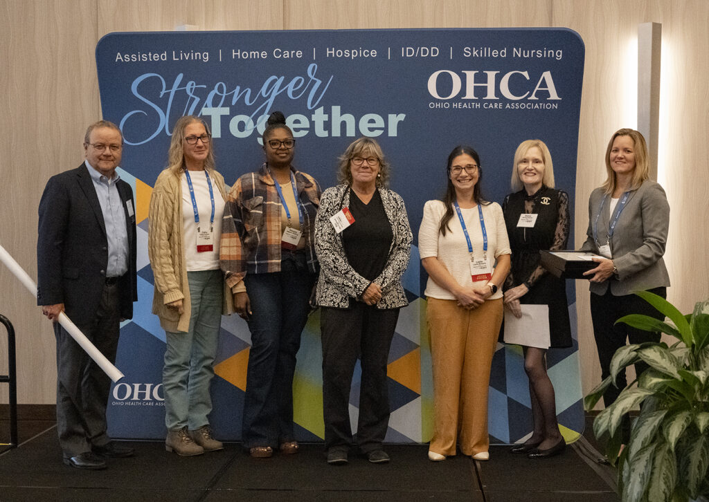 Award winners pose on stage during OHCA's 2023 Excellence Awards