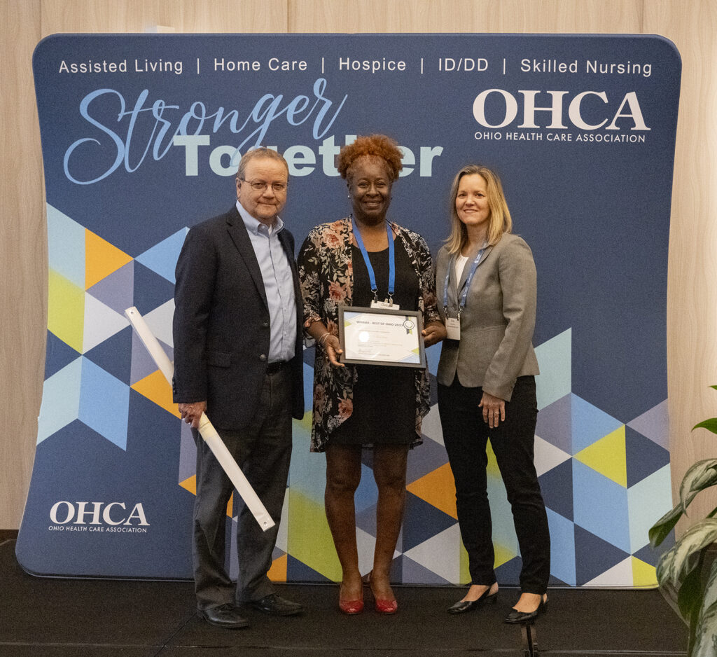 An award winner and presenters during OHCA's 2023 Excellence Awards