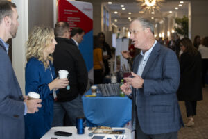 Business people chat at booths during the Conway Center Expo