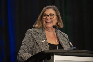 Speaker smiles at podium during the event photography coverage for the Conway Family Business Awards 2023