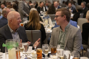 business people of multiple generations speak during the event photography coverage for the Conway Family Business Awards 2023