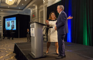 Welcoming a speaker to stage during the event photography coverage for the Conway Family Business Awards 2023