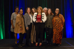 An award winner and her team pose with their award during the event photography coverage for the Conway Family Business Awards 2023