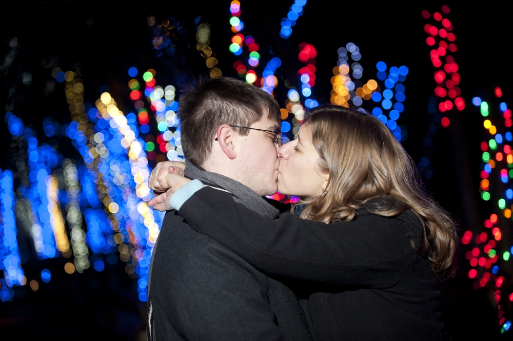 Engagement Photography - Kissing in front of Christmas Lights
