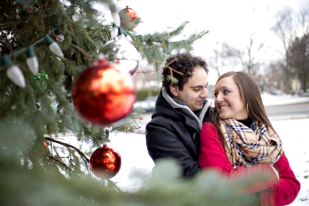 Engagement Photography - Winter couple embracing next to Christmas tree