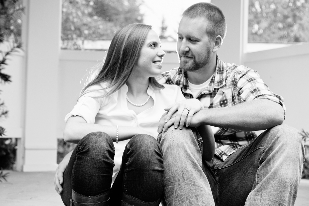 Engagement Photography - Couple sitting holding hands smiling at each other