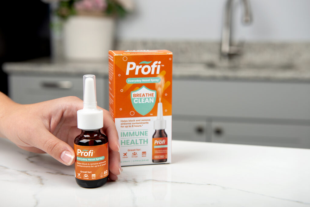 product photo in kitchen setting of nasal spray and box with hand model