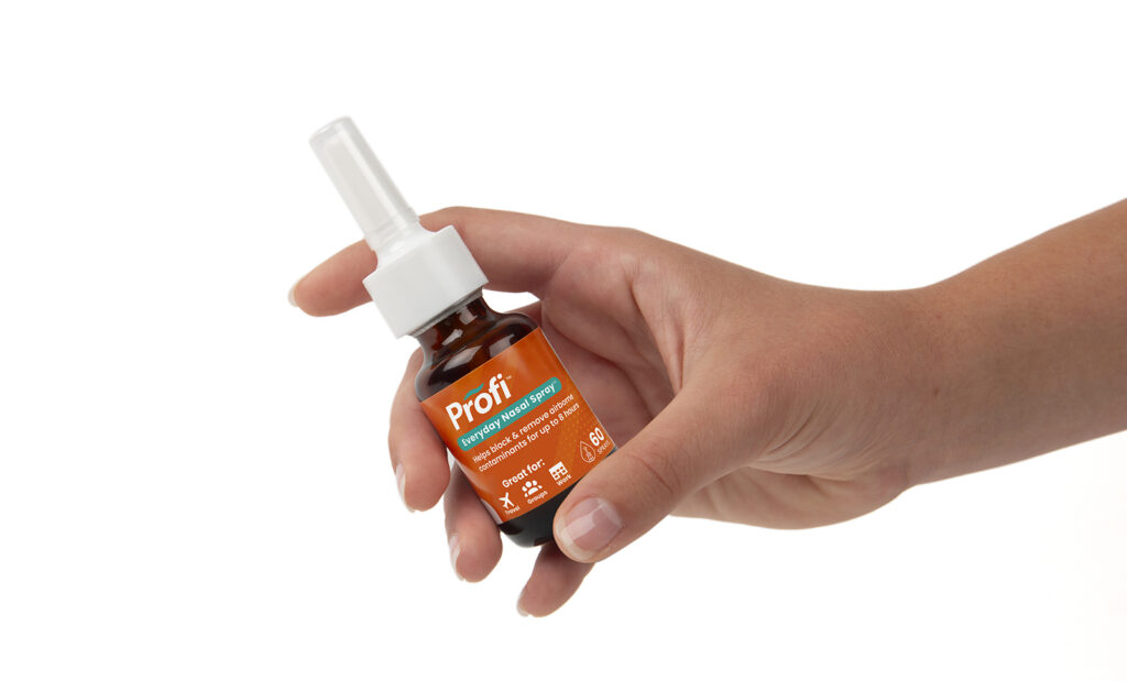 Product photo with hand model for Akita Biosciences Nasal Spray on white background